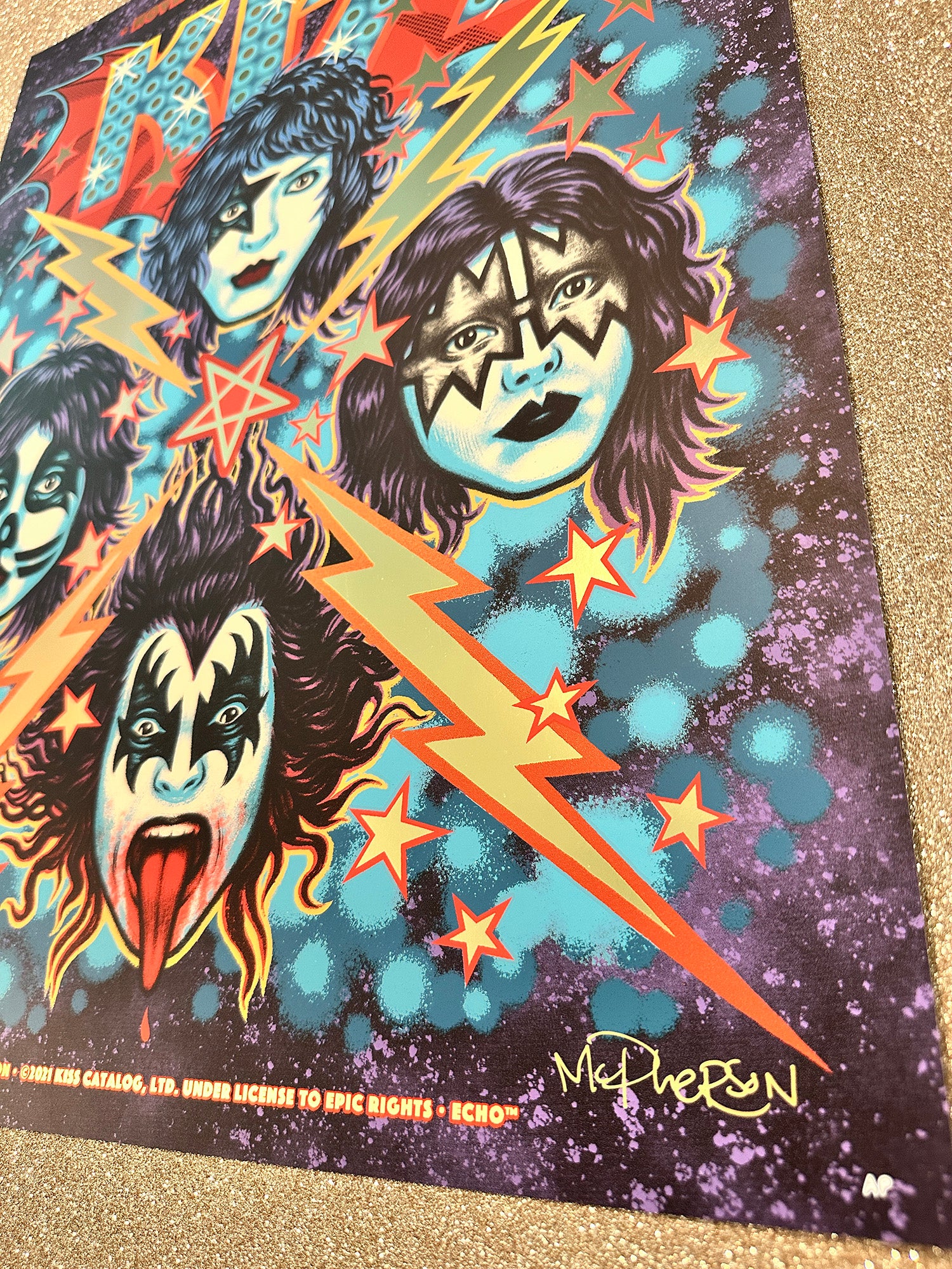 Colorful poster of KISS band members with lightning bolts and stars on a dark background.