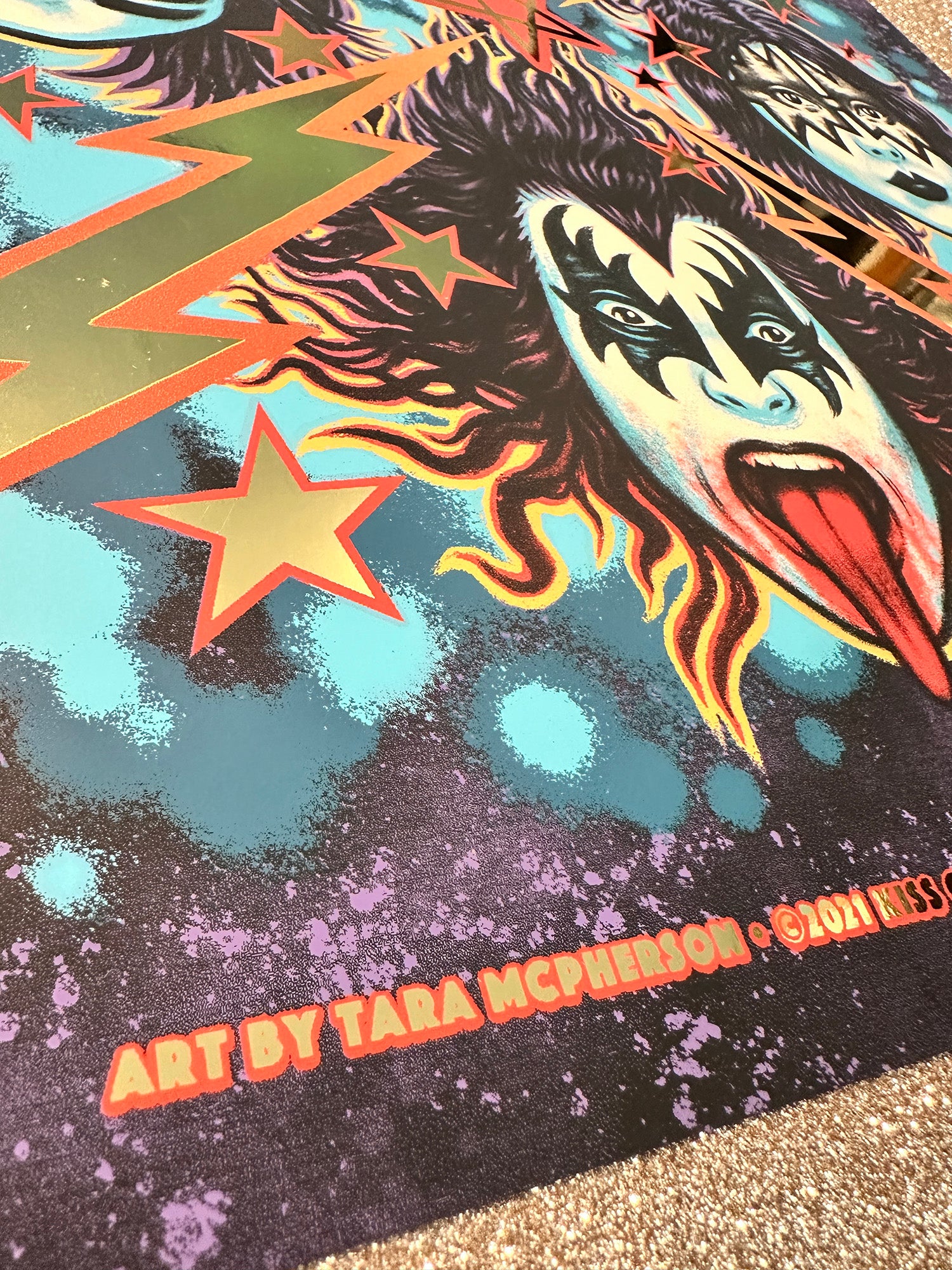 Colorful graphic design with a face and star, featuring the text 'Art by Tara McPherson'.