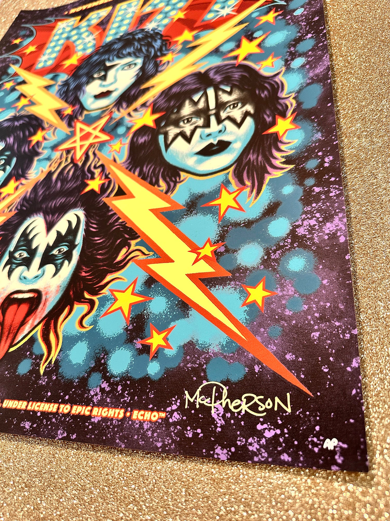 Kiss-themed poster with colorful graphics on a glittery surface