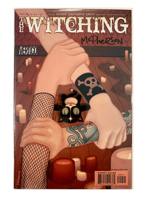 The Witching Series #9 comic book featuring artwork by Karen Gallagher and McPherson, showing a stylized illustration of tattooed arms holding a small black cat in a candle-lit room. Signed by Tara McPherson 
